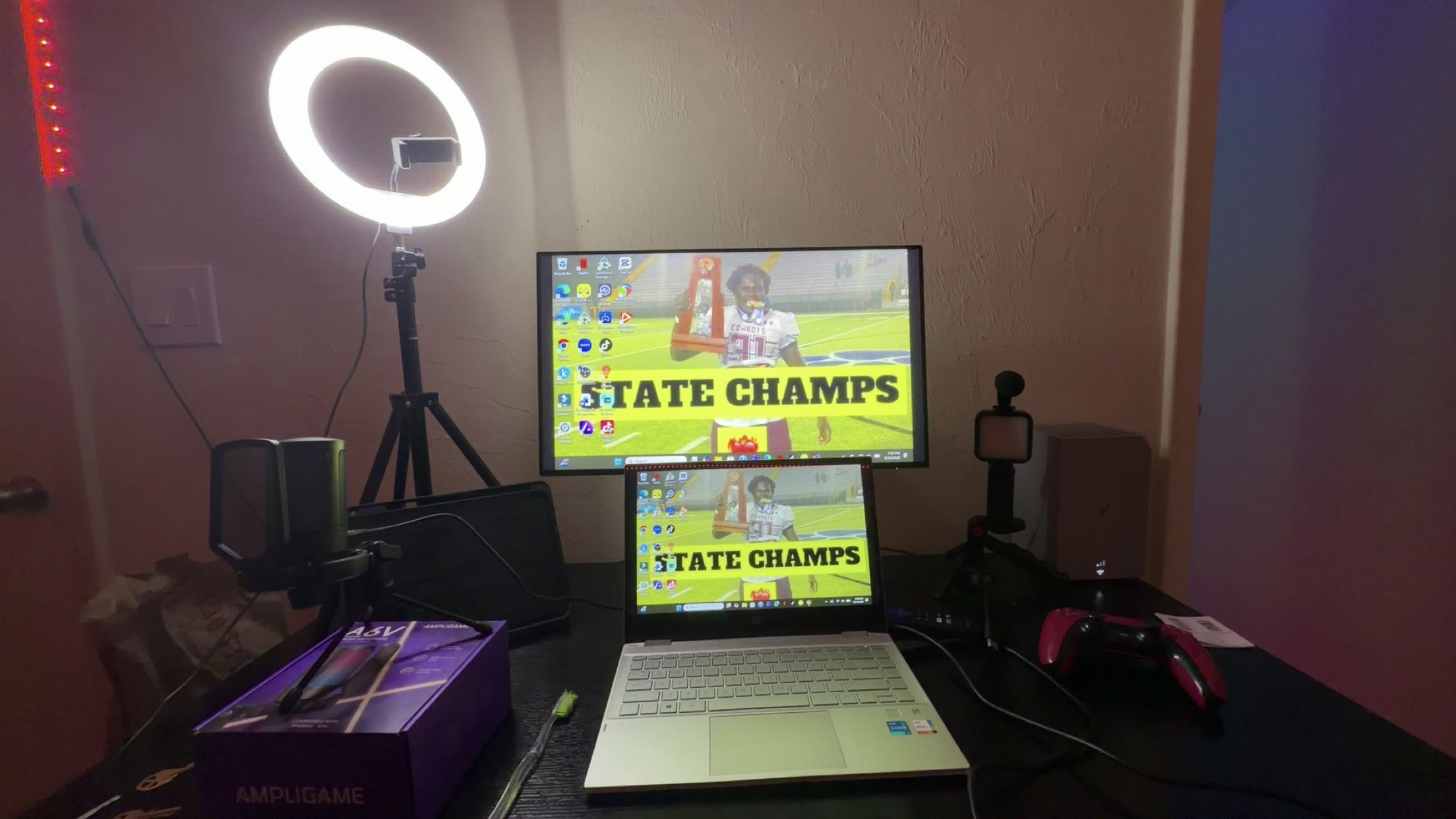 Mahri’s streaming desk with a ring light, microphone, monitor, laptop and game controller.