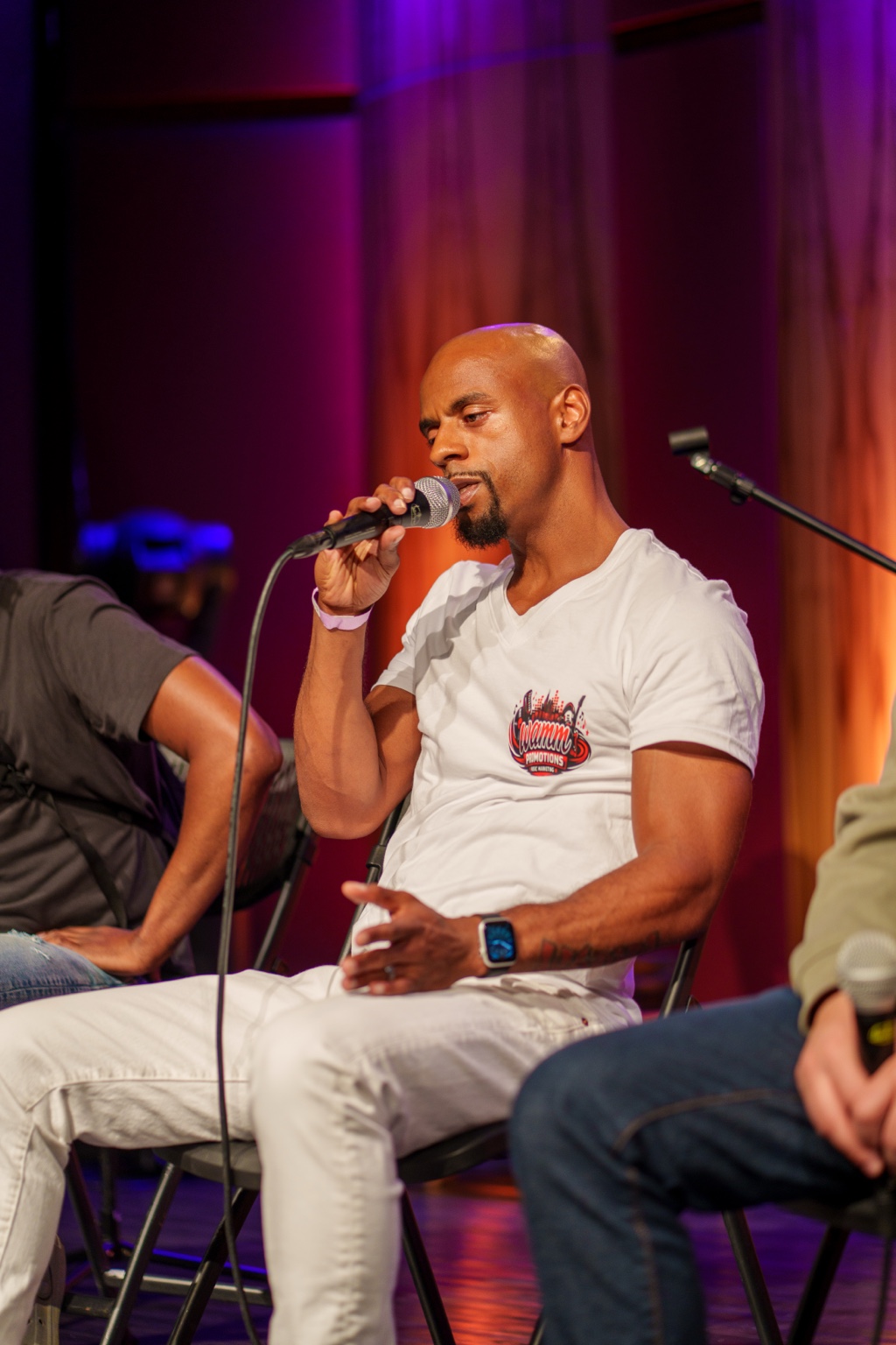 Bernard Martin speaks during the #iDoit4mycity Masterclass while wearing a WAMM Promotions shirt.