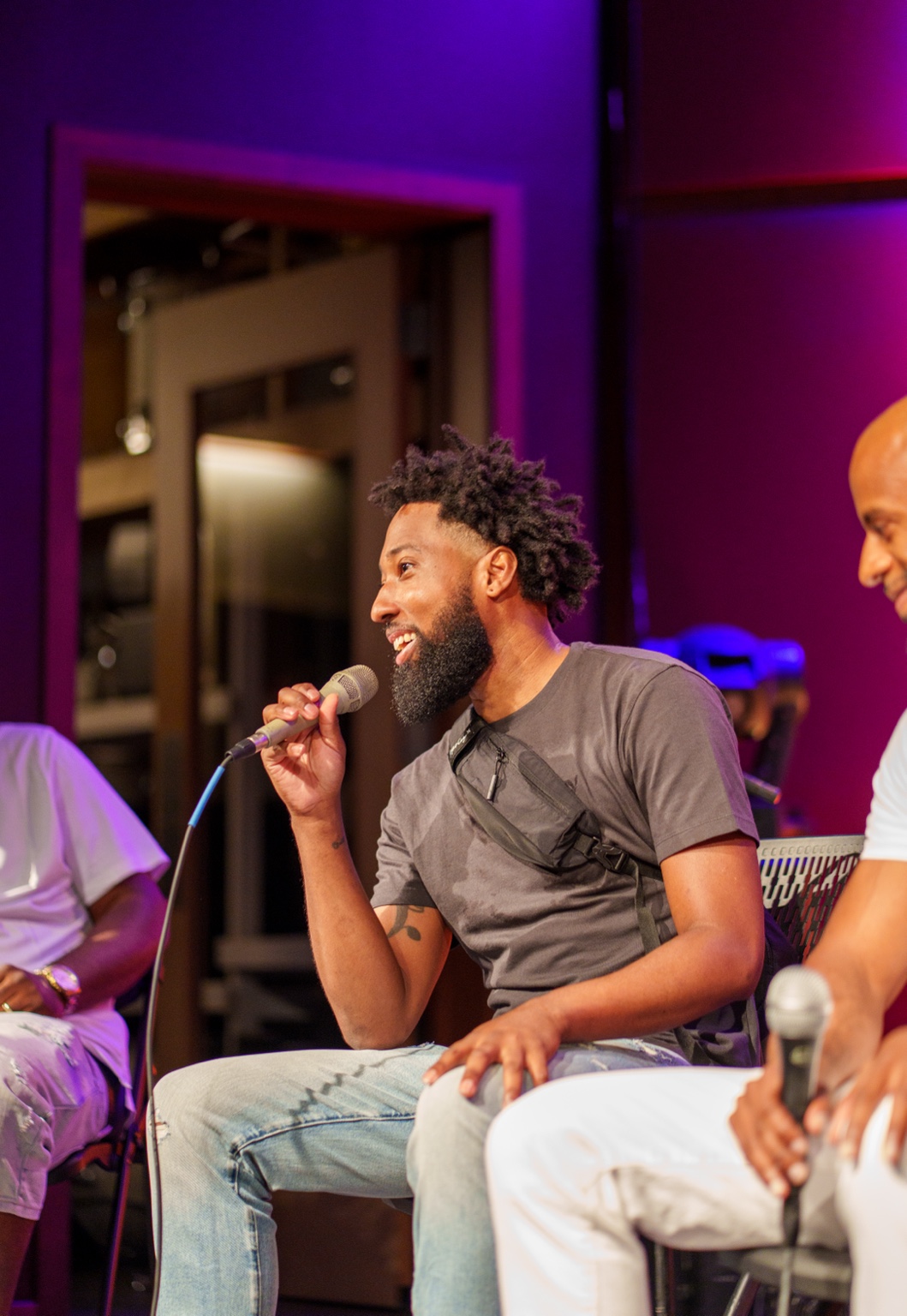 Evan Melville speaks into a microphone during the #iDoit4mycity Masterclass.