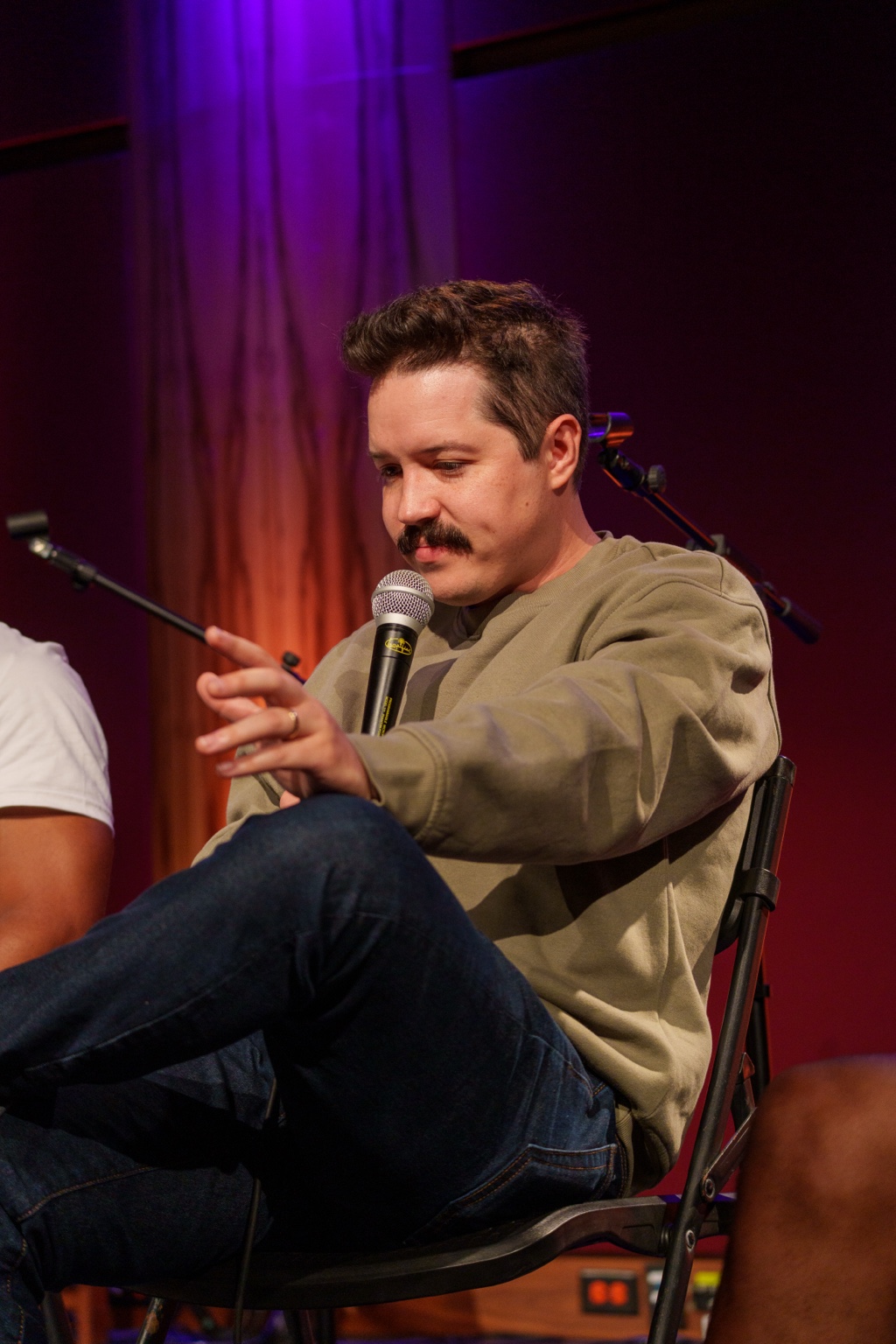 Ryan Schmidt, Esq. speaks into a microphone during the #iDoit4mycity Masterclass.
