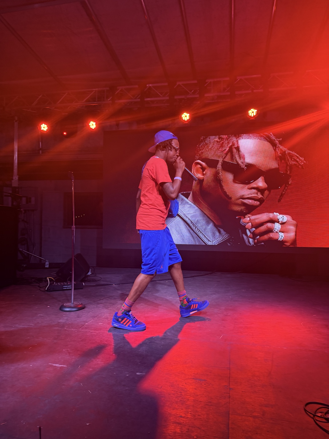 Trap Beckham performs on the Heartwood Soundstage under red lighting during the #iDoit4mycity Festival.
