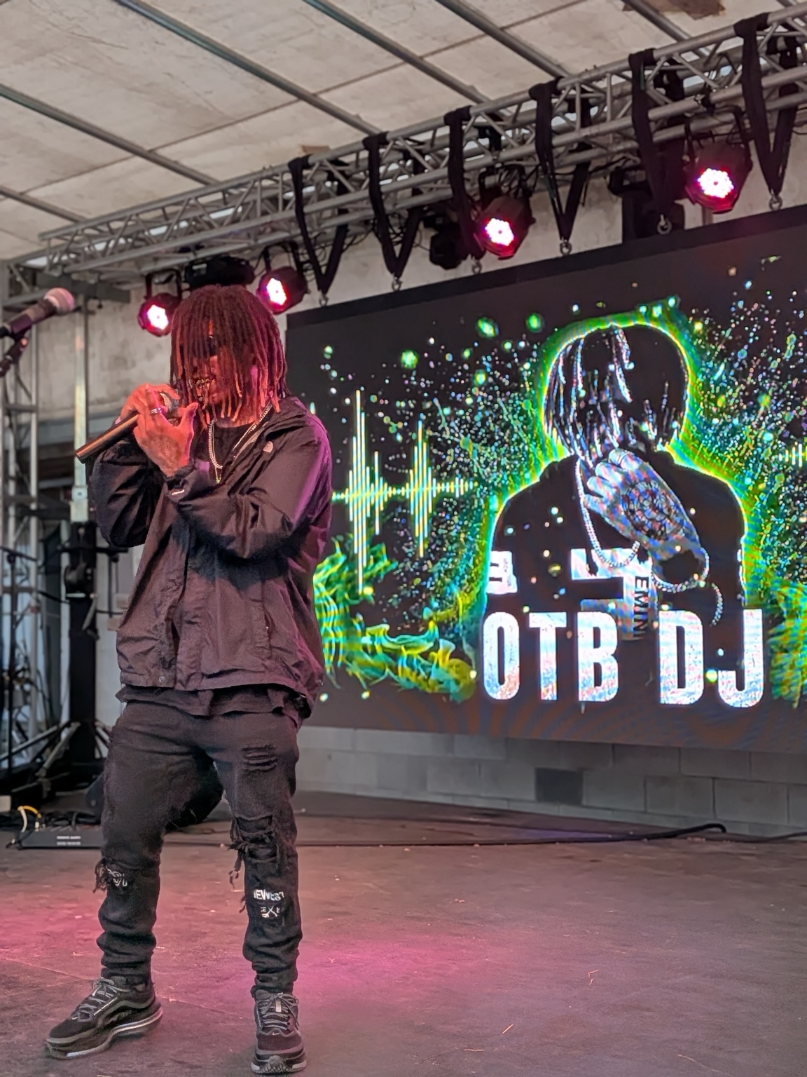 OTB DJ performs on the Heartwood Soundstage with his artist graphic on the LED screen.